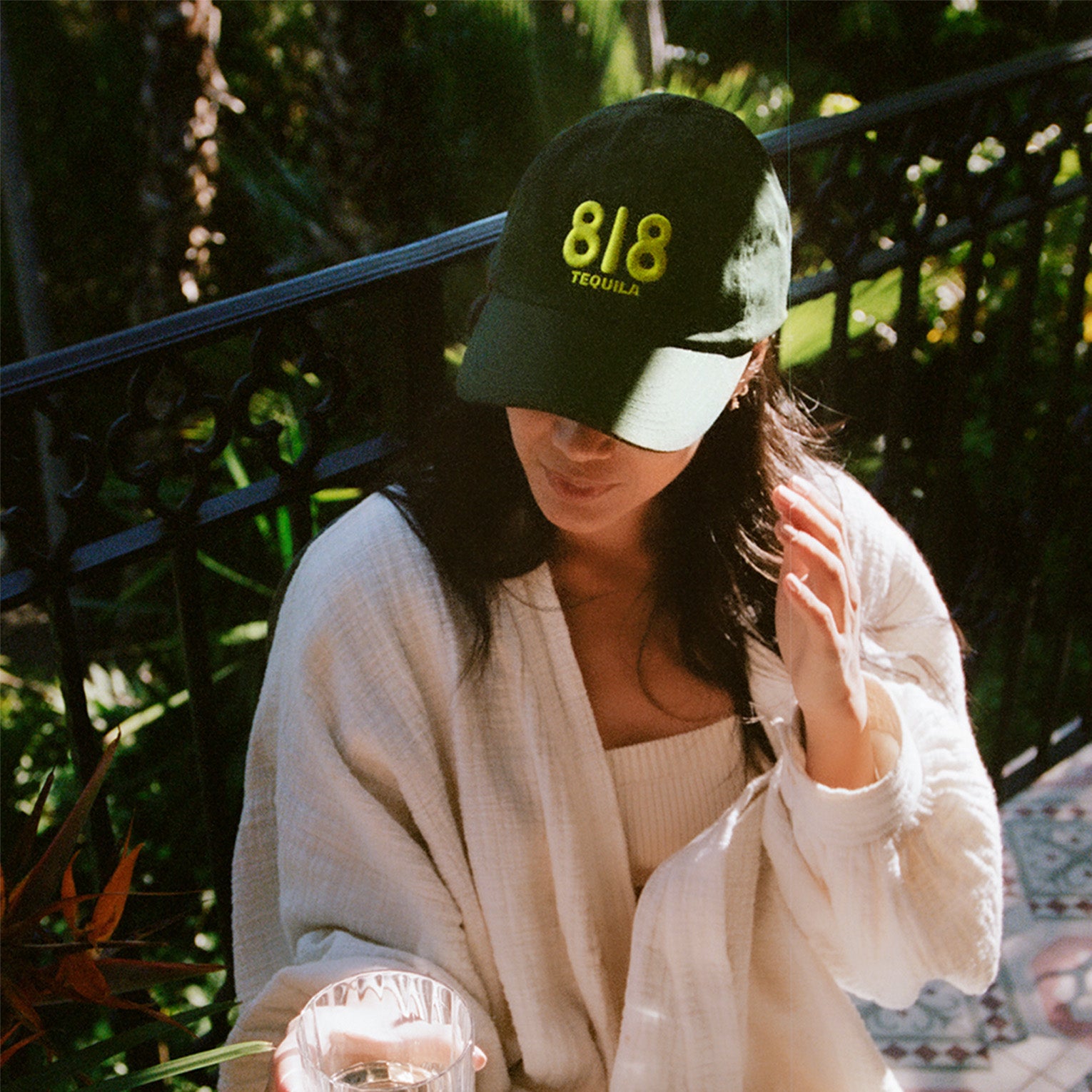 Person sitting outside wearing the 818 dad hat