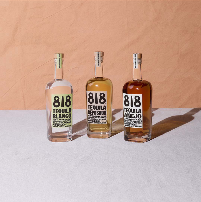 818 Tequila Bottles staged on white and terra cotta colored backdrop